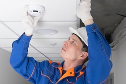 master of fire alarm maintenance, conducts an inspection in the residential sector