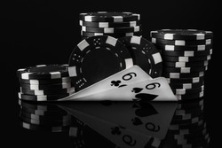black white idea of poker chips and poker cards in poker on a black background