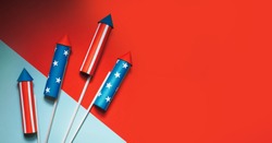 July 4, rockets for fireworks on a blue red background with space for text. in the style of minimalism