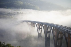bridge in the fog over the canyon