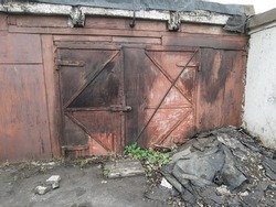 old garages. vintage gate. sturdy old doors. parking for cars. vintage door lock