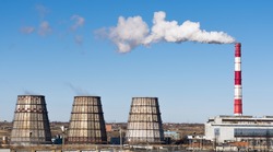 Industrial landscape. Thermal power plant with smoking chimneys. Horizontal rectangular photo.