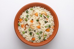 indian veg biryani, veg pulav, Indian vegetable pulav, Biriyani, vegetable Biriyani served in a terracotta bowl 