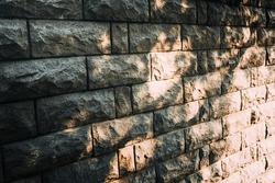 background stone wall wall with patches of sunlight, light and shadow, solar hares, stone wall sun