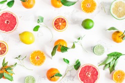 Fruit pattern. Colorful fresh fruits on white table. Orange, tangerine, lime, lemon, grapefruit. Flat lay, top view