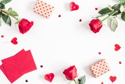 Valentine's Day. Frame made of rose flowers, gifts, candles, confetti on white background. Valentines day background. Flat lay, top view, copy space.