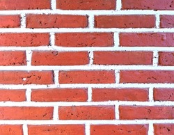 Red brick wall background with white stripes