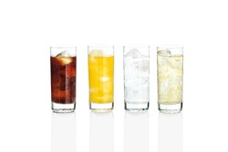 Glasses with sweet drinks with ice cubes isolated on white