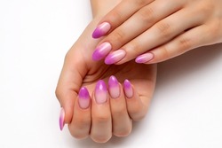 Ombre on the nails. French lilac manicure on long oval nails on a white background close-up.