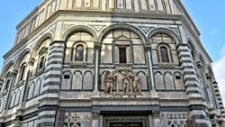 The Baptistery is one of the oldest buildings in Florence Italy. 4th century. Iconic octagonal basilica with striking marble facade, known for its bronze doors and mosaic ceiling. Italy, Florence 