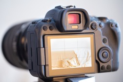 Close up of a professional digital camera on a blurred background.