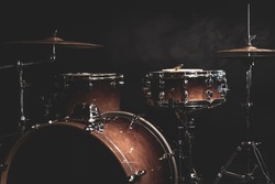 Part of a drum kit on a black background, percussion instrument, snare drum, bass drum, hi-hat.