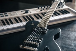 Close up, electric guitar and piano, musical creativity concept.