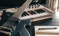 Close-up, electric guitar and piano, the concept of musical creativity, modern musical instruments.