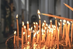 Close-up, candles in the temple on a blurred background, the concept of religion and faith.