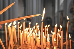 Close-up, candles in the temple on a blurred background.