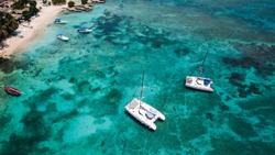 Sailing catamaran. Yachts and boats in the bay. Beautiful bay with turquoise water. View from above