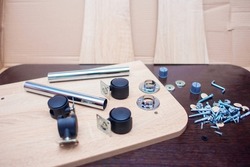 Fasteners for collecting furniture. A set of fasteners for assembling the table. Screws and furniture components, furniture wheels