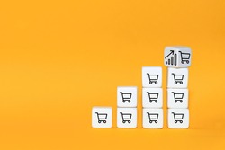 Sale volume increase make business grow. The cube turns over with icon graph and shopping cart symbol.