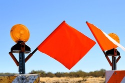road closure construction barricade with bright orange caution flags
