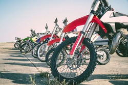 Motocross bike stand in a row. Motocross tires and wheels