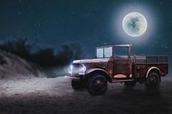 The wreck of a military jeep parked beautifully on the desert on a full moon night.