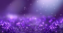 Glitter background dark purple saturated color ,de-focused, macro. Sequins fall and sparkle, free space