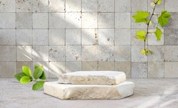 Original template for spa product presentation. Pedestal of marble slabs and branches with green leaves  against  background of wall in bathroom with masonry in light beige colors.