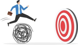 Overcoming difficulty to achieve target, aspiration to finish mission, facing business obstacle for success and experience concept, Businessman jumping over messy ball to reach target.

