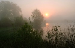Foggy morning. Dawn outside the city. It will be a warm day. Morning fog on the lake.
Sunrise