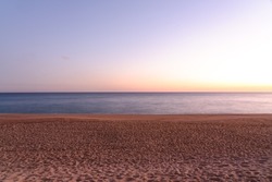 long exposure shot of sandy beach at sunset, empty beach 