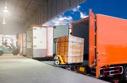Packaging Boxes on Pallet Loading into Shipping Cargo Container. Delivery Trucks. Supply Chain. Trucks Parked Loading at Dock Warehouse. Shipment. Cargo Freight Truck Transport Logistics.