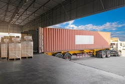 Industry Cargo Freight Trucks Transport and Logistics. Trailer Container Truck Parked Loading Package Boxes at the Warehouse. Supply Chain. Distribution Warehouse Center. Shipping Shipment Cargo.