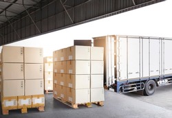 Industry Cargo Freight Trucks Transport Logistics. Shipping Cargo Container Trucks Parked Loading Packagin Boxes at Dock Warehouse. Supply Chain. Distribution Warehouse Center. Shipment Boxes.