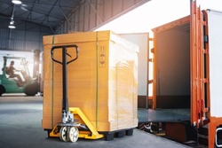 Cargo Box with Hand Pallet Truck  is Loading into a Container. Shipment Supply Chain Delivery. Warehouse Logistics. Cargo Freight Truck Transportation.	