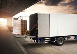 Workers Unloading Packaging Boxes into Cargo Container. Delivery Trucks Shipment. Trucks Loading at Dock Warehouse. Supply Chain Goods. Distribution Warehouse Shipping Cargo Transport Logistics.