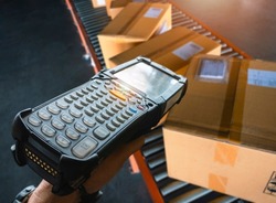 Close up, Workers Scanning Bar Code Scanner with Packaging Boxes on Conveyor Belt. Shipping Supplies Warehouse. Computer Mobile Work Tools for Inventory Management. Storehouse. Shipment Pacel Boxes.