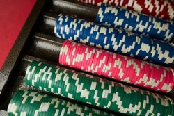 Poker chips colorful gaming pieces lie on the game table in the stack. Background for gambling, casino, business, poker. Colorful casino chips for casino game on the table. Soft focus