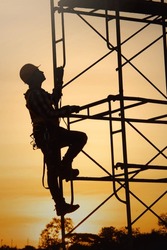 Silhouette young construction worker working on construction during sunset background job