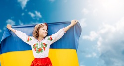 Ukraines Independence Flag Day. Constitution day. Ukrainian child girl in embroidered shirt vyshyvanka with yellow and blue flag of Ukraine in field. flag symbols of Ukraine. Kyiv, Kiev day