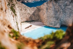 Navagio beach or Shipwreck bay. Turquoise sea water and white beach between huge rocky cliffs. Famous landmark location on Zakynthos island, Greece