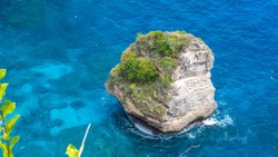 Lonely Rock in Sea Watter, North Coast, Nusa Penida, Bali, Indonesia