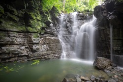 A smooth flowing waterfall deep in the jungles of the Ecuadorian rainforest in the Amazon. 