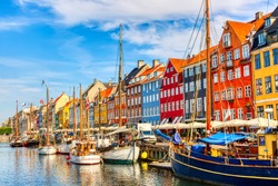 Copenhagen iconic view. Famous old Nyhavn port in the center of Copenhagen, Denmark during summer sunny day.