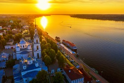 Aerial drone view of Kineshma ancient city with Volga river in Ivanovo region, Russia. Summer sunny day sunset.