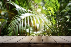 Dark wood table top (Bar) with blur on green palm leaves or tree in tropical forest with bokeh light at background - Using for Mock up template for display of your design.