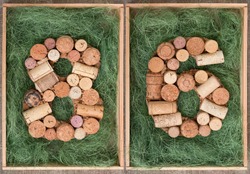 Number 86  eighty six  made of wine corks on green background in wooden box