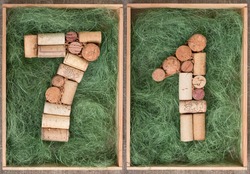 Number 71 seventy one  made of wine corks on green background in wooden box
