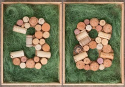 Number 38 thirty eight made of wine corks on green background in wooden box
