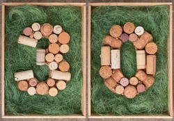 Number 30 thirty made of wine corks on green background in wooden box